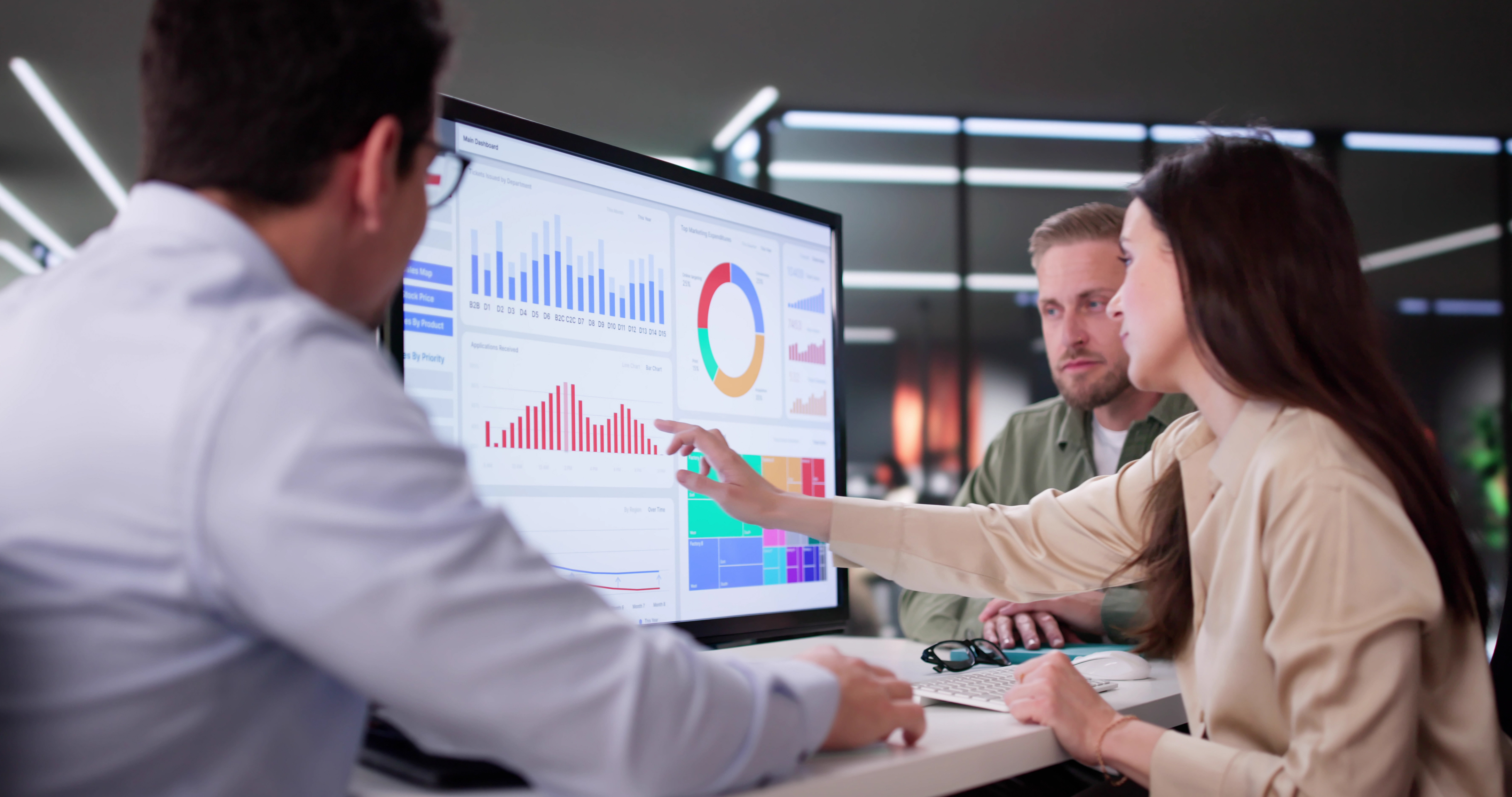 A team of analysis looks at a screen showing rate info.