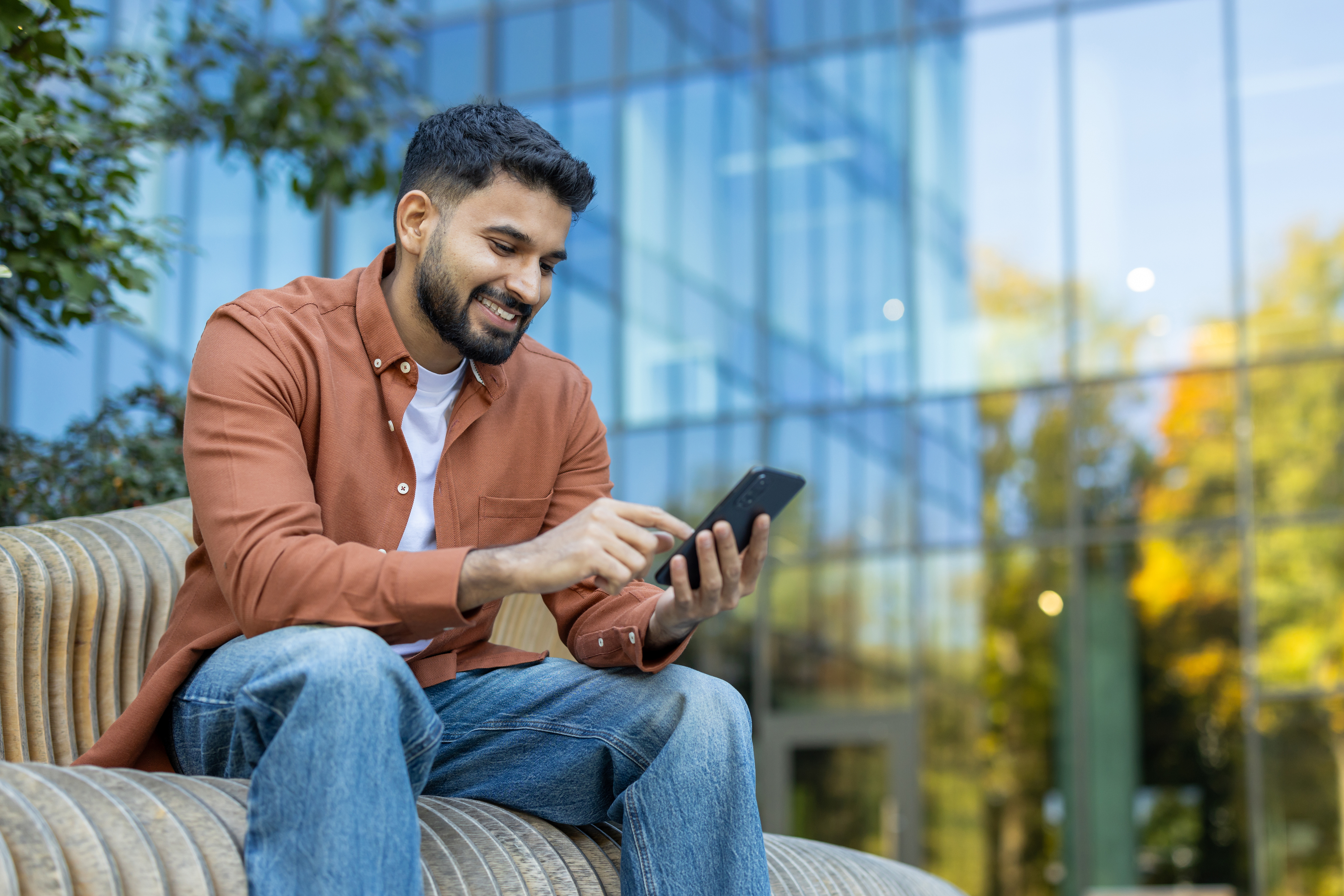 A man uses his phone to explore online mortgage options.